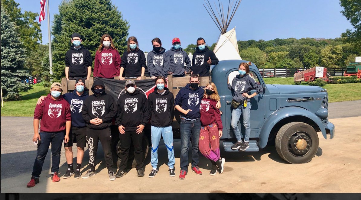 The Kaiser Cat Collective team gathered in front of a vintage truck